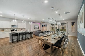 A modern kitchen with a central island, bar stools, and pendant lighting. - Sleeps 25•Game Room•Pool•Free Water Slides (Davenport)