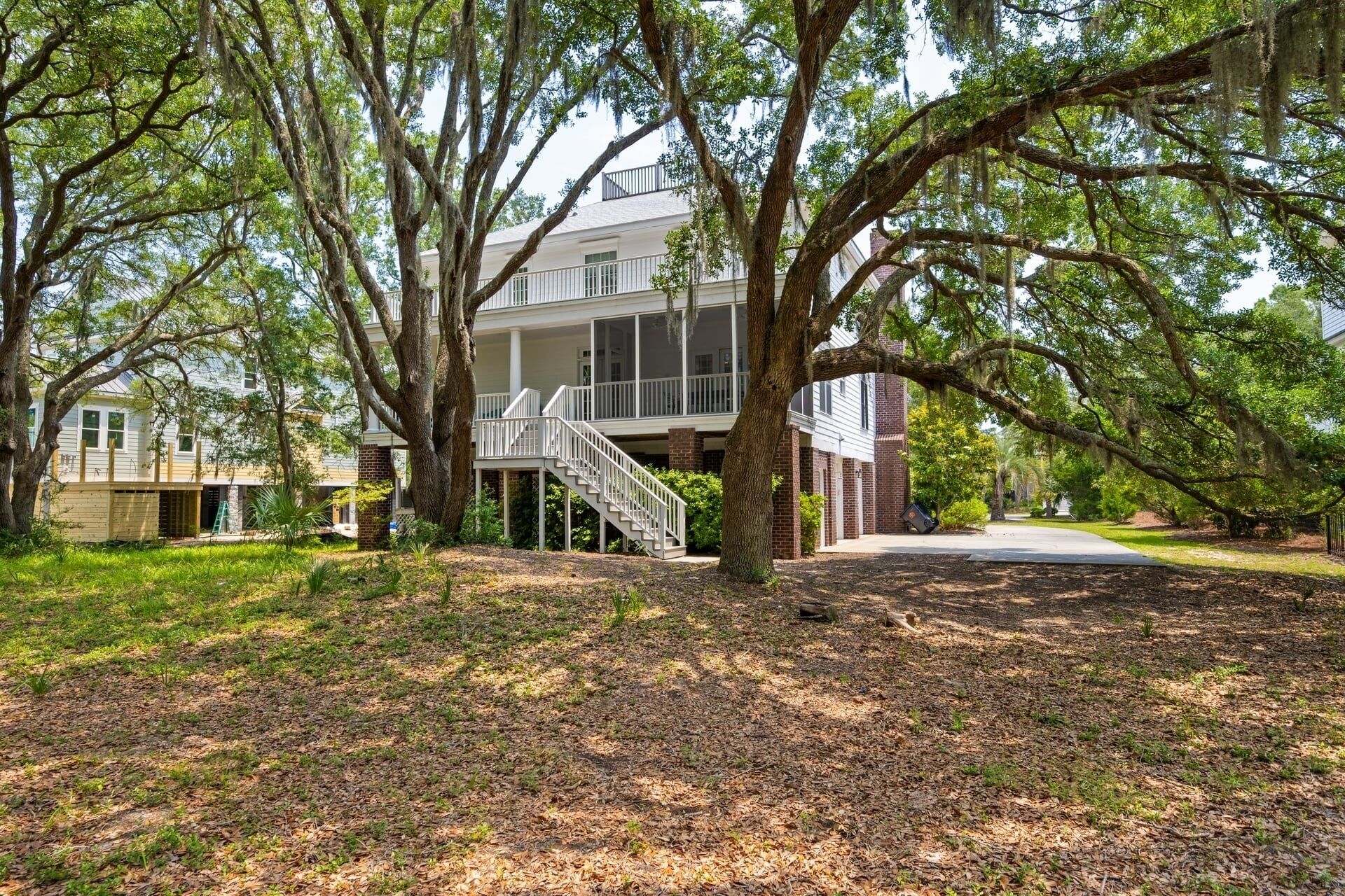A two-story house with a covered porch and a staircase leading to the second floor.