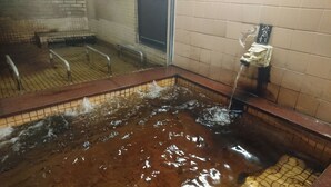 A public bath area with a large, rectangular hot spring filled with water. - Hotel Yuou Onsen  (Kofu)