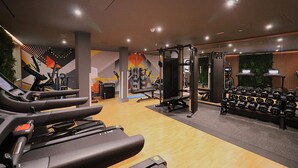 A gym with treadmills, weight machines, and a rack of dumbbells. - Student Only Bargate House (Southampton)