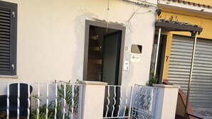 A residential building with a gated entrance, a visible staircase, and a garage door. - Gold Leaf Sicily "Superior Triple Room" Taormina center (Taormina)