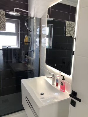 Shower, hair dryer, towels, soap
