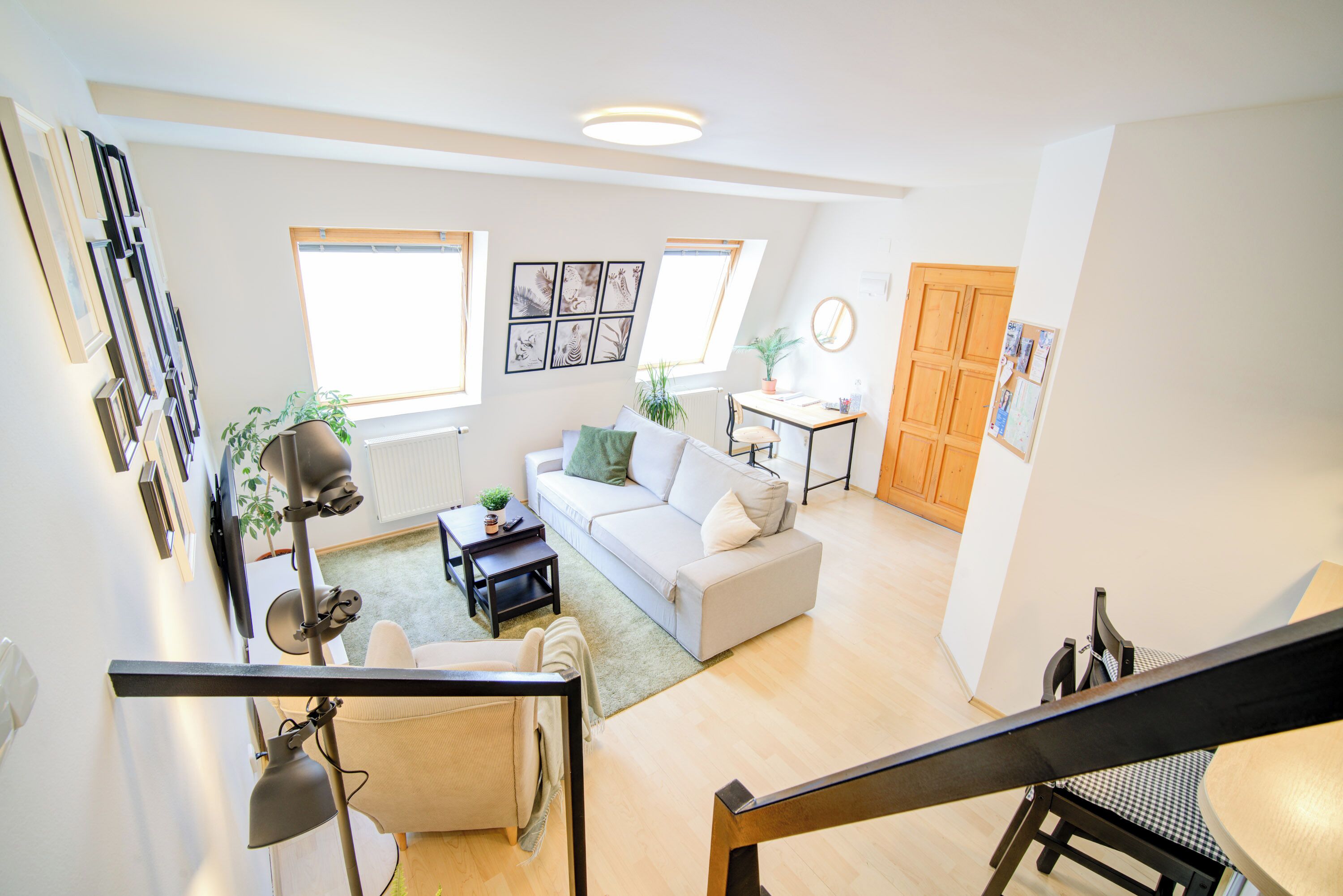 A spacious living room with a sofa, coffee table, and a dining area with a table and chairs.