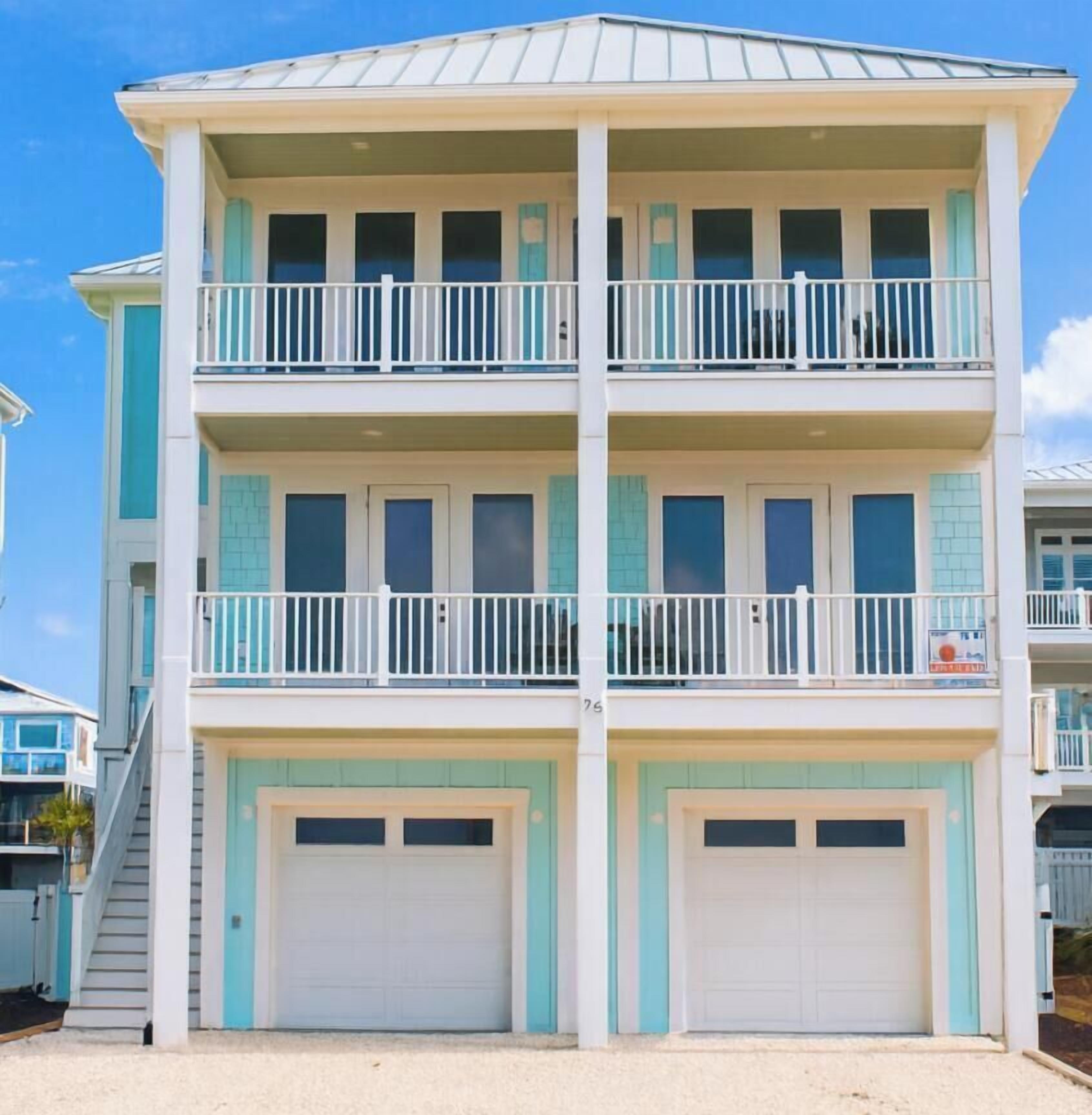 A multi-story building with balconies and garage doors.