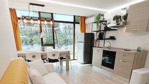 A modern living room with a sofa and a dining area.