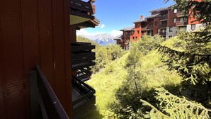 A view of a mountain resort with wooden buildings and lush greenery.