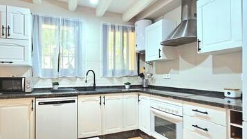 Familie appartement, 3 slaapkamers, uitzicht op tuin | Privékeuken | Een koelkast/vriezer, een kookplaat, kookgerei, borden en bestek