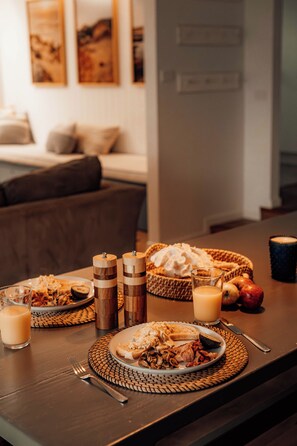 A dining table set with breakfast items including toast, eggs, bacon, and fruit. - Quay-Walk to beach Gas Heated Pool, Spa Trampoline (Blairgowrie)