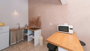 A compact kitchen with a microwave, sink, and a small refrigerator. - Villa IVKA Apartment D - terrace with panoramic views, 1 BR + ensuite bathroom (Brela)