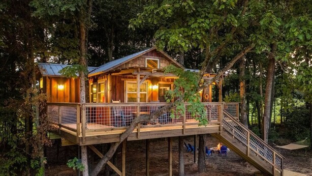 A wooden cabin with a balcony, surrounded by trees. - Cherry Treesort "The Tolson" (Rowan County)