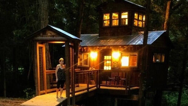 A wooden cabin with a porch and a small deck, surrounded by trees. - Cherry Treesort "Sweet Ashley" (Rowan County)