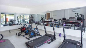 A modern gym with treadmills, stationary bikes, and free weights. - Luxurious Studio close to USA embassy (Accra)