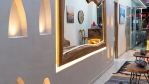 A hallway with a large mirror, recessed lighting, and a patterned rug. - Eros Hotel (Ksamil)