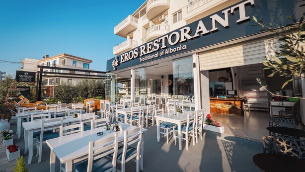 A restaurant with outdoor seating, a balcony, and a sign stating 'Traditional of Albania.' - Eros Hotel (Ksamil)