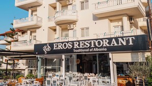 A multi-story building with a restaurant named 'Eros Restaurant' on the ground floor. - Eros Hotel (Ksamil)