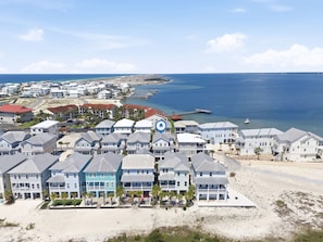 A coastal residential area with beachfront properties, a pier, and a boat dock. - 🌊 Sugar Beach | Soundside Access, Resort Perks, 4BR Family-Friendly (Navarre)