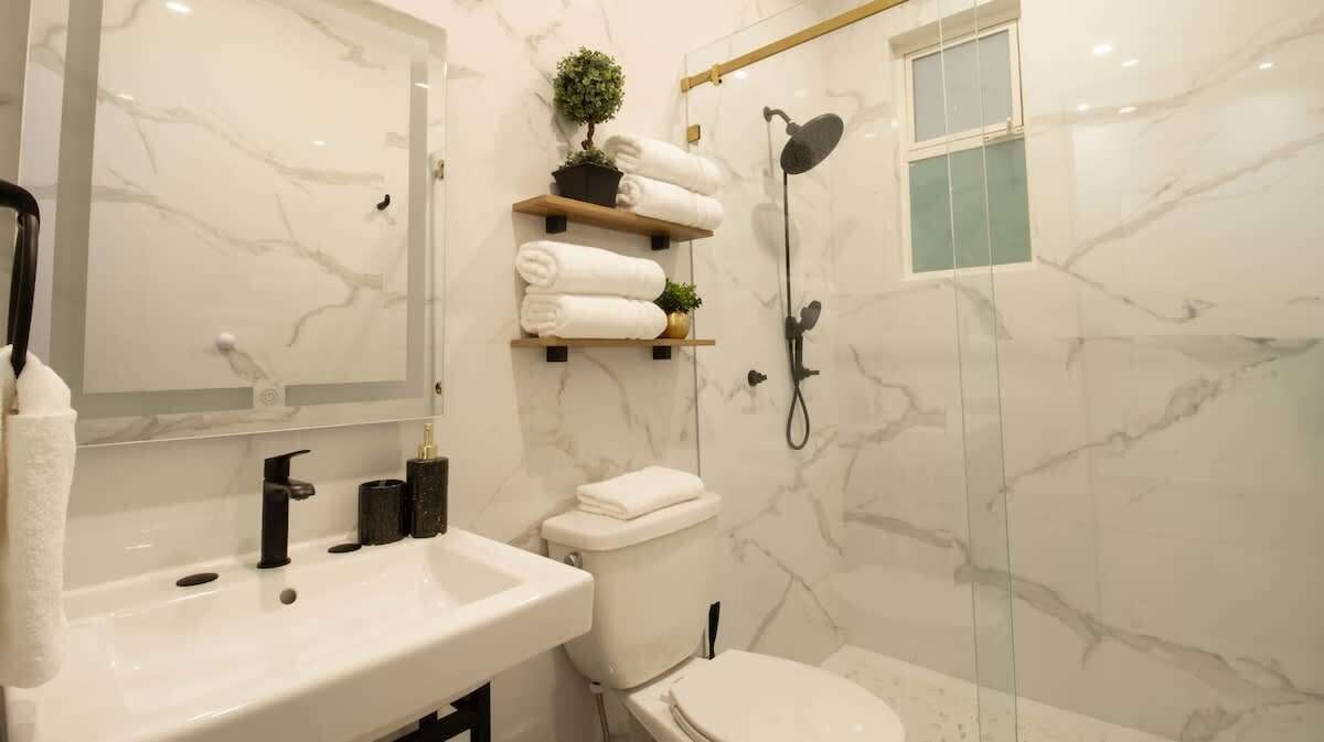 The bath is stocked with quality towels and the shower has dual heads