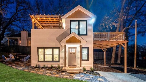 A two-story house with a front porch, a deck, and a small garden area with outdoor seating. - 2 Bedroom Loft Style Home in ATL near Downtown (Atlanta)