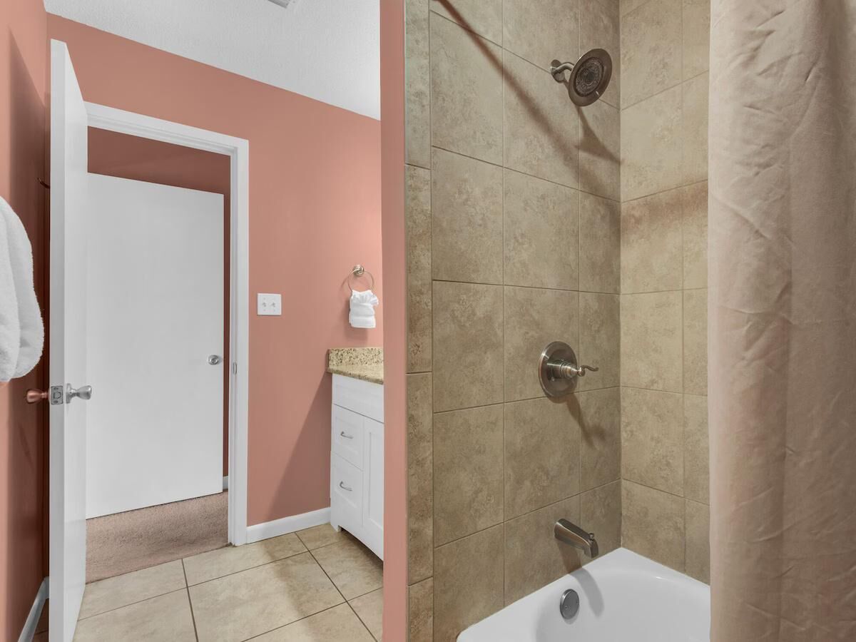 A bathroom with a bathtub, a shower, and a sink.