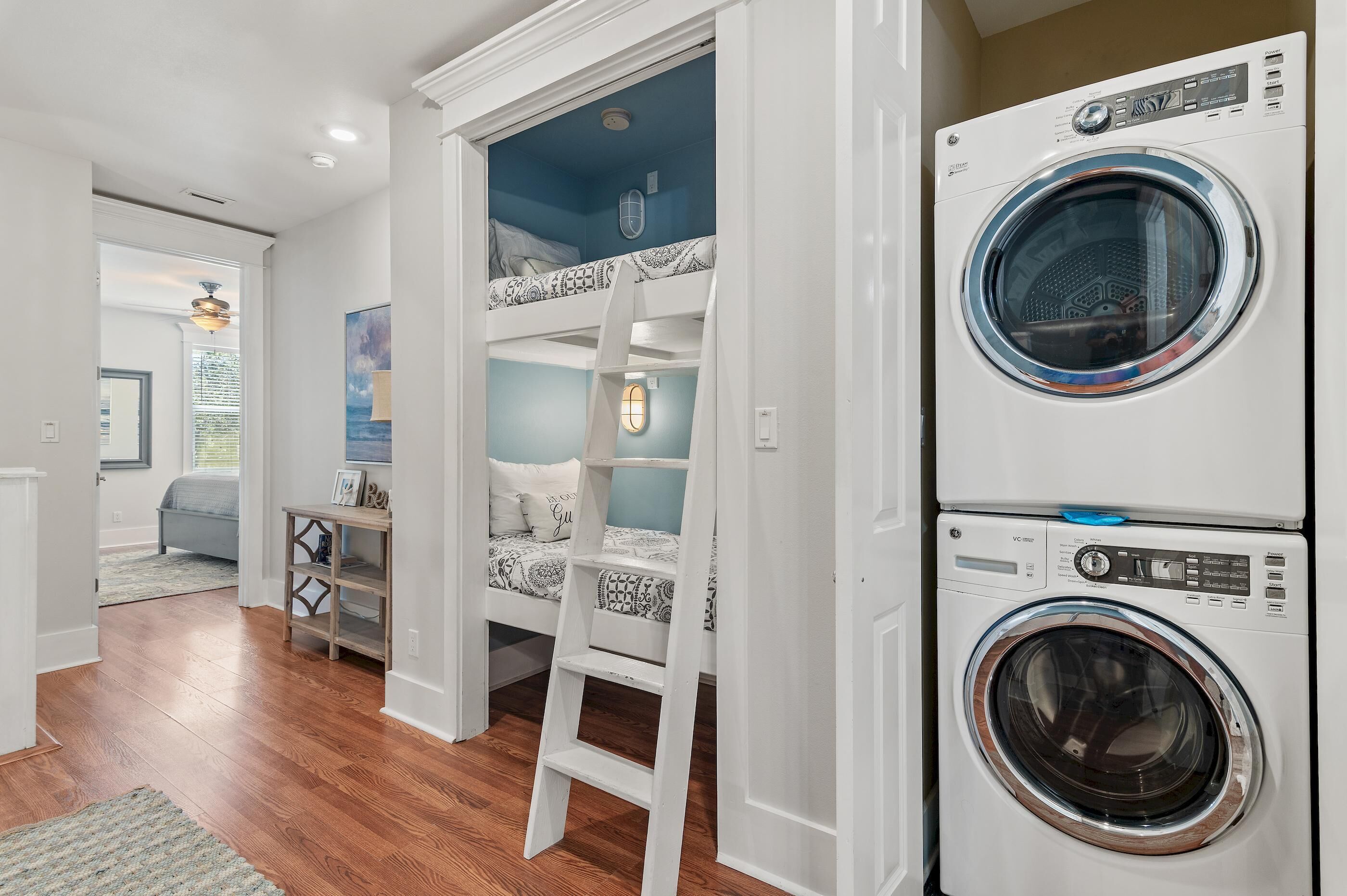 A laundry room with two stacked front-loading washing machines.