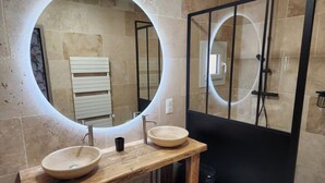 A bathroom with two round sinks, a wooden vanity, and a glass shower enclosure. - Charming apartment (Allauch)