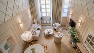 Deluxe Duplex | Living area | 32-inch flat-screen TV with cable channels