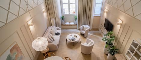 Deluxe Duplex | Living area | 32-inch flat-screen TV with cable channels