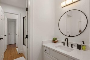 Shower, hair dryer, towels, shampoo