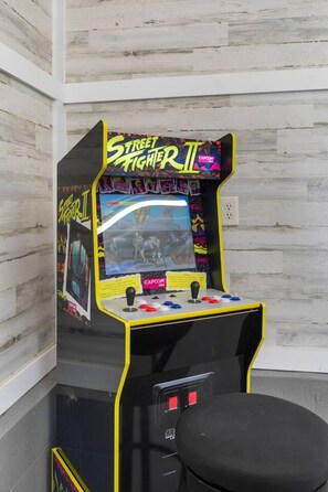 A Street Fighter II arcade game machine with two joysticks and a monitor.