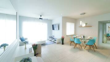 Superior Apartment, Garden View | Living area | 80-cm TV with digital channels
