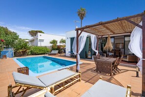 A pool area with lounge chairs and a covered seating area. - Anana Binisafua Villa With a Pool by the sea (Sant Lluis)