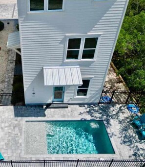 A two-story house with a small front porch and a swimming pool. - A Serenity by the Sea St George Island Pool Home (Eastpoint)