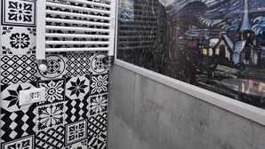 A bathroom with a large window featuring a famous painting of a starry night. The walls are decorated with black and white patterned tiles. - THE FIVE SAILS*****Water Front LUXURY HOUSE Genoa (Genova)