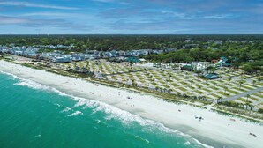 An aerial view of a coastal resort with a sandy beach, clear blue waters, and a well-organized layout of buildings and green spaces. - 2B/2B COZY BEACH GETAWAY IN OCEAN LAKES RESORT MYRTLE BEACH SC w/GOLF CART (Myrtle Beach)