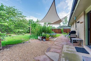 A patio with stone tiles, a barbecue grill, outdoor furniture, and potted plants. - < 1 Mi to CU Boulder: Home w/ Fenced Yard! (Boulder)