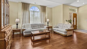 A living room with two sofas, a wooden coffee table, and a cabinet with drawers. - Explore Ramona's Vineyards: Tranquil Home w/ Yard (Ramona)