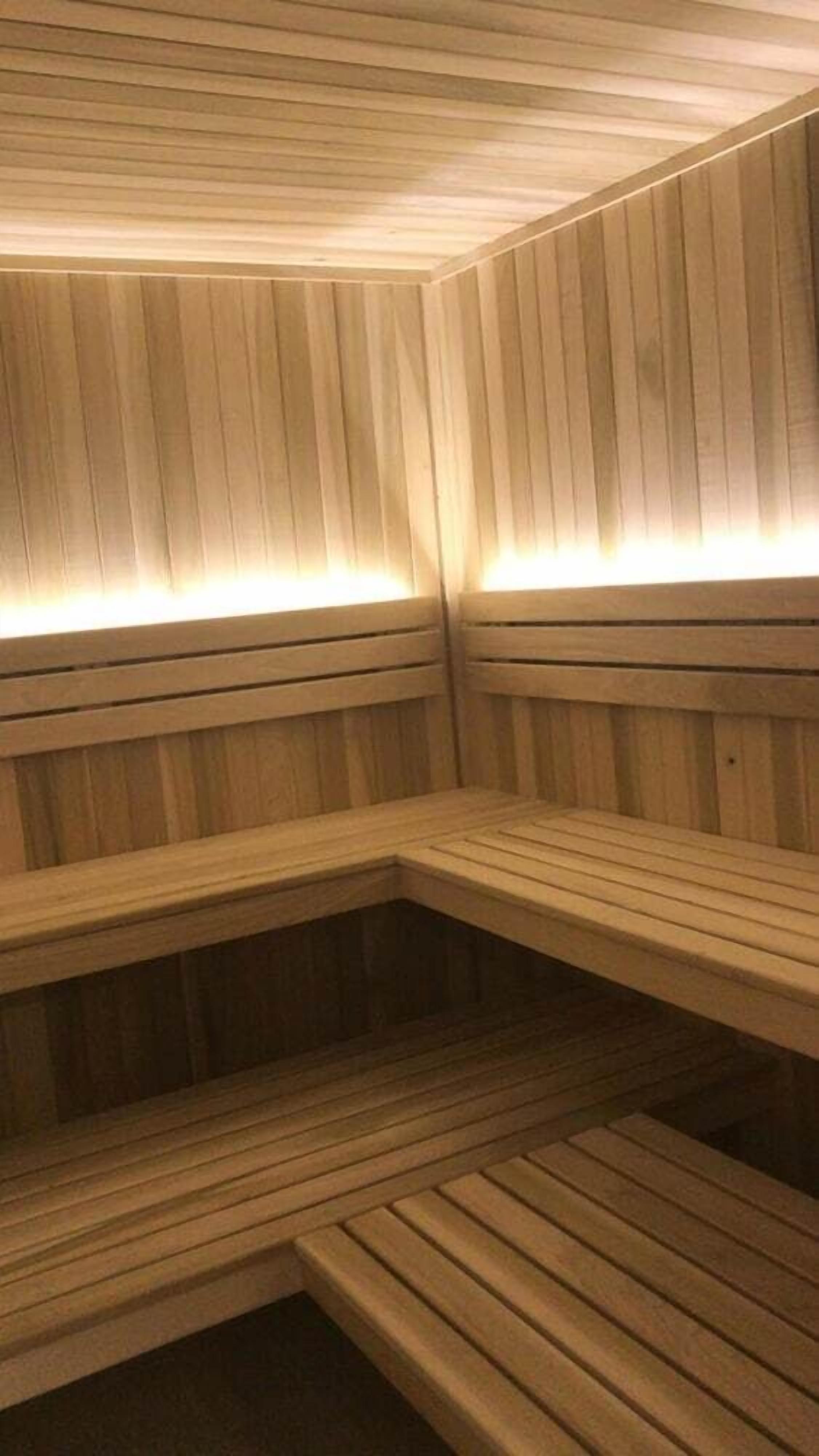 A sauna with wooden benches and slatted walls.