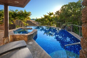 A swimming pool with a hot tub, surrounded by tropical plants and a clear sky. - Luxe Oceanview Getaway w/ Heated Pool & Epic Sunrise (As Seen on TV) (Koloa)