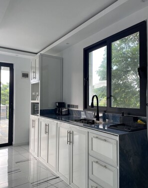 Fridge, microwave, stovetop, coffee/tea maker
