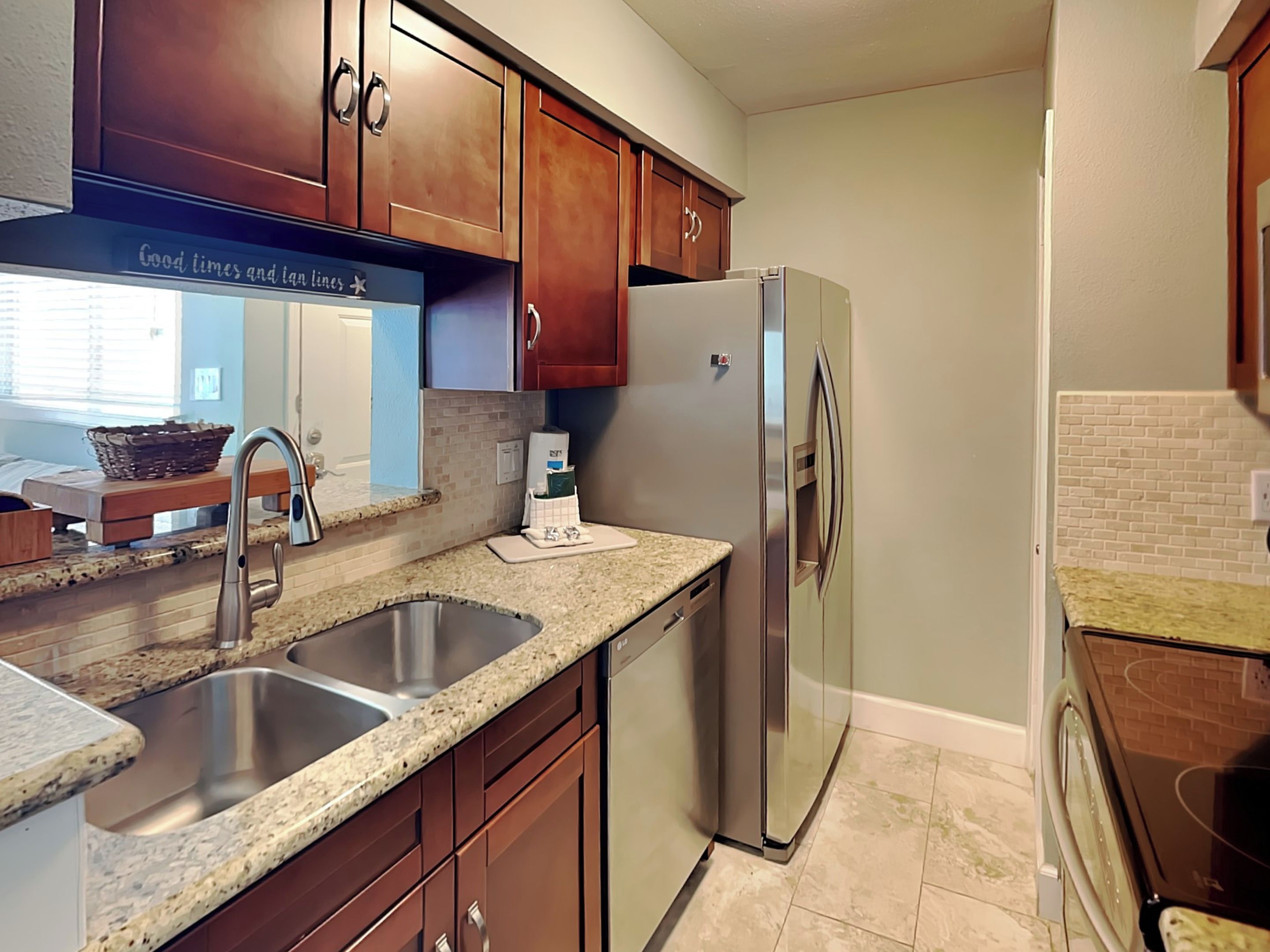 A kitchen with granite countertops, stainless steel appliances, and wooden cabinets.