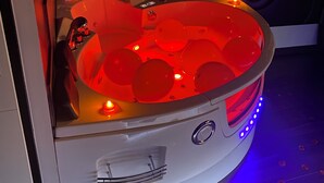 A spa room with a heated tub, a control panel, and LED lighting. - ✨Unique and romantic suite with private spa✨ (Voiron)