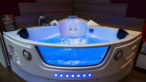 A modern spa tub with a built-in heater, a control panel, and a glass front. - ✨Unique and romantic suite with private spa✨ (Voiron)