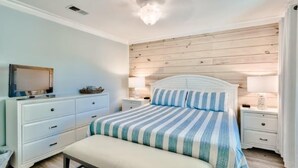 A bedroom with a bed, nightstands, a dresser, and a television. - Blue Surf 5 (Miramar Beach)