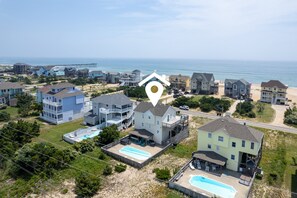 Zona residencial costera con casas, una playa y un muelle.
