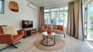 A living room with a TV, sofa, and coffee table. - 2 bedroom lovely home in Hellendoorn (Hellendoorn)