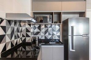 Fridge, microwave, coffee/tea maker, cookware/dishes/utensils