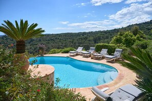 A swimming pool with lounge chairs and a view of a forested hillside. - La Bastide Vence by Avecoeur (Saint-Paul-de-Vence)