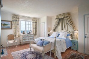 A bedroom with a bed, a chair, a dresser, and a window with curtains. - La Bastide Vence by Avecoeur (Saint-Paul-de-Vence)