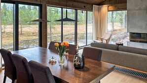 A modern interior with a dining table, chairs, a sofa, and a fireplace. - 4 bedroom stunning home in Eggedal (Eggedal)