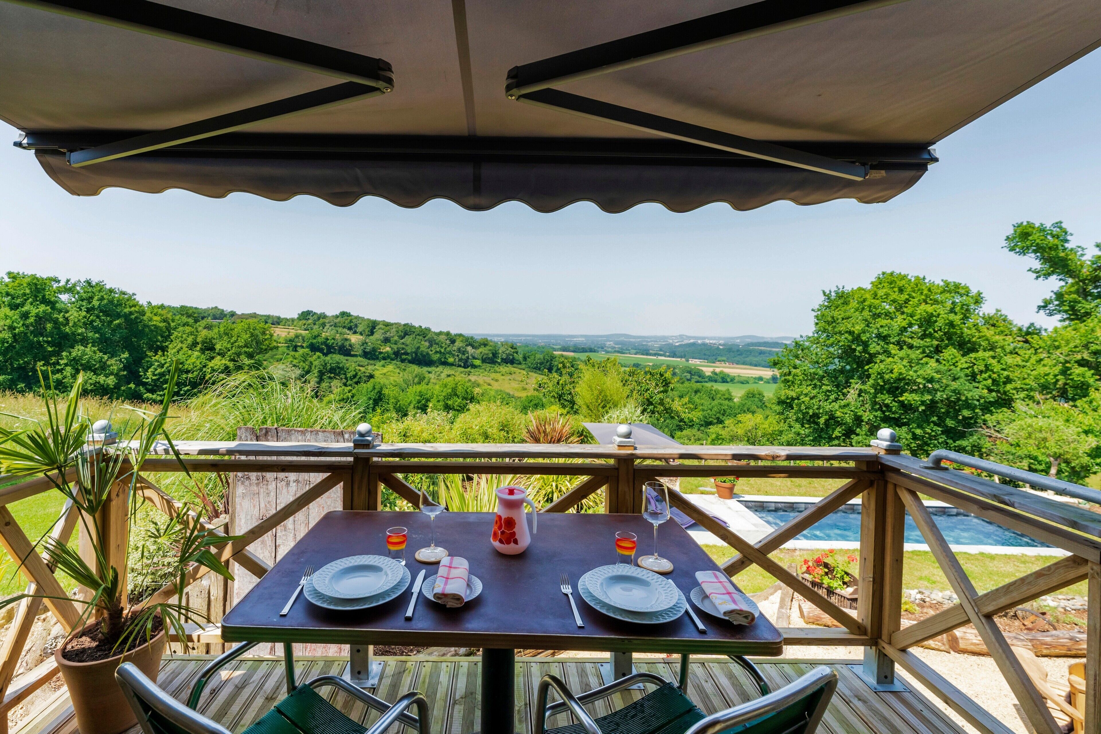 A dining table set outdoors with a scenic view.